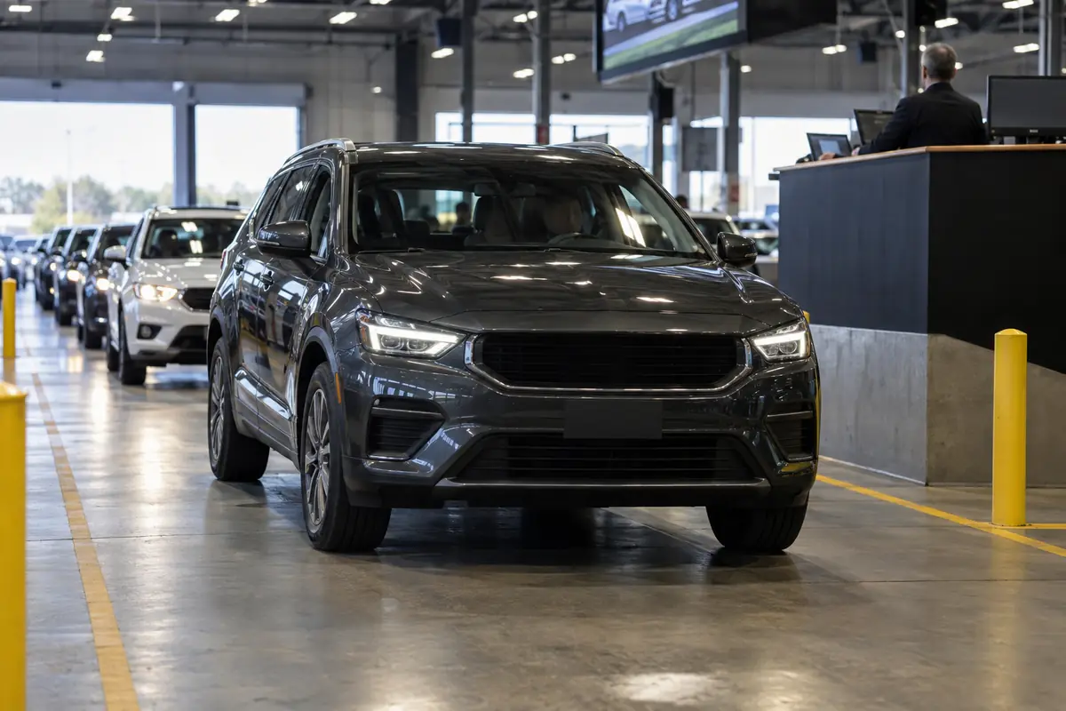 SUV rolling through an indoor dealer auction lane
